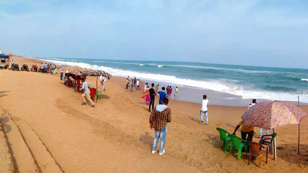 Visitors walking along Chandrabhaga Beach near Konark